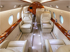 Interior of Gulfstream G200 jet with leather seats and round windows