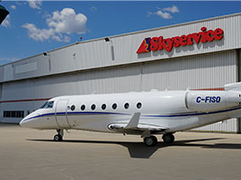 Side view of Gulfstream G200 jet exterior in front of Skyservice facility