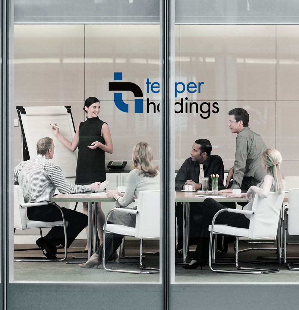 Professionals meeting in conference room Tepper Holdings logo on back wall